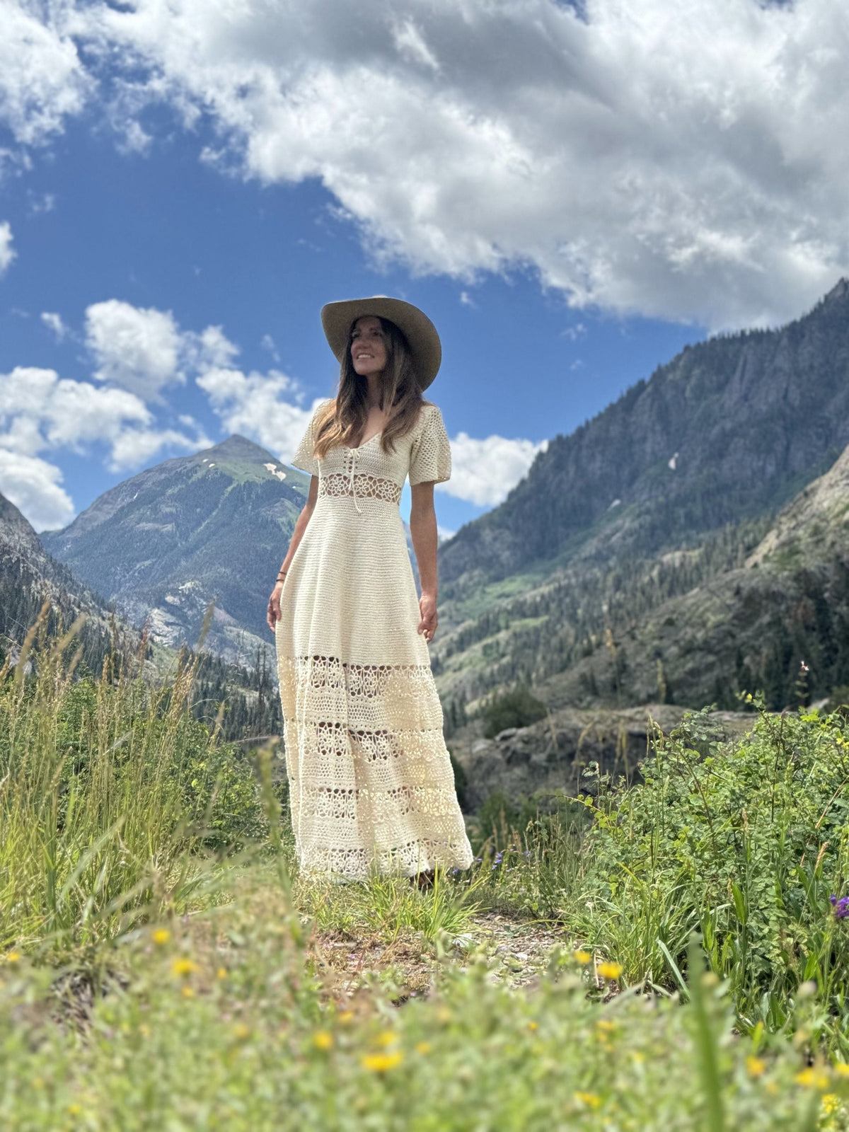 Dimension crochet dress pattern in ivory - long lace dress worn in a Colorado mountain valley - Mermaidcat Designs