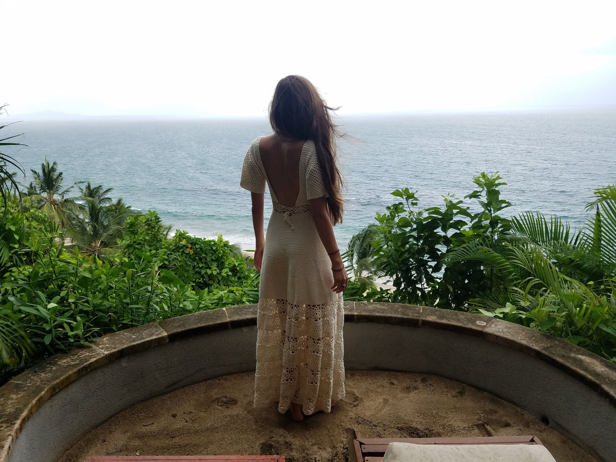 Dimension crochet dress pattern - back view of the long lace dress overlooking the ocean - Mermaidcat Designs